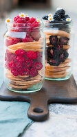 Pancakes layered with raspberries and blackberries in screw-top jars