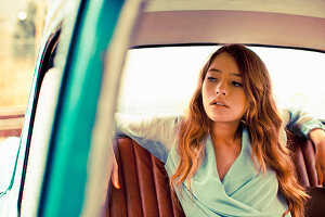 A young woman sitting in a car