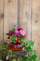 Late summer bouquet with rose hips surrounded by hop vines