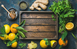 Ingredients for making natural hot drink: oranges, mint, lemons, ginger, honeycomb and apple