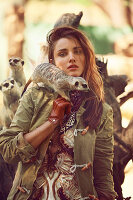 A brunette woman with meerkats