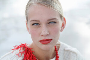 A young blonde woman with red lipstick