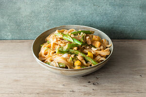 Vegan rice noodles with a fruity mango and peanut sauce