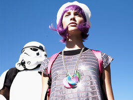 A young woman with purple hair standing next to a Stormtrooper