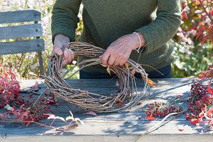 Autumn wreath with rose hips and wild wine