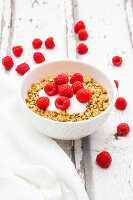 Granola with yoghurt and raspberries in a bowl