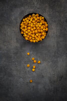 A bowl of chickpeas roasted in turmeric as a healthy snack (seen from above)