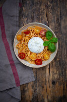 Spaghetti with pesto rosso, cherry tomatoes and burrata