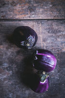 Round eggplants on a wooden surface