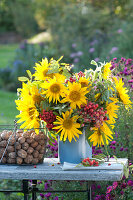 Late summer bouquet with sunflowers, rowan berries and crab apples