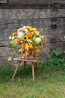 Autumn bouquet of hydrangeas, chrysanthemums, sunflowers and oak leaves