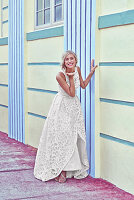 A young blonde woman wearing a white wedding dress