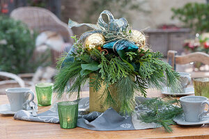 Christmas bouquet in golden vase as table decoration