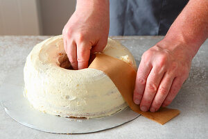 A Frankfurt wreath cake being made: cream being smoothed