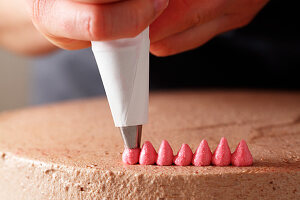 Cream dots being piped from a piping bag