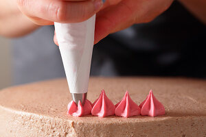 Cream stars being piped with a piping bag