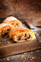 Apple strudel being dusted with icing sugar