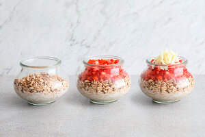 Muesli being layered in a jar