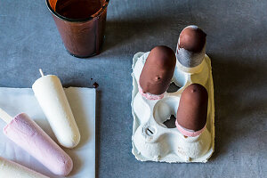 Ice cream being covered in chocolate and left to dry