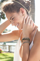 A young woman wearing hair jewellery and a white, backless top