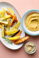 Oven-roasted vegetables with hummus for a mother and puréed for the baby