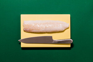 Fresh fish fillet with a knife