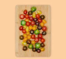 Colourful tomatoes on a wooden board