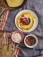 Pancakes with chocolate cream and grated coconut