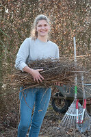 Woman doing spring cleaning in the garden