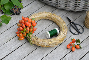 Autumn wreath with rose hips on a straw wreath