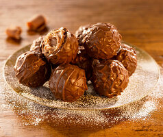 Milk chocolate truffles on a gold plate