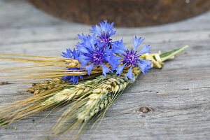A bouquet of cornflower, ears of rye and barley