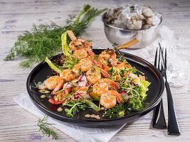 Fried shrimp kebab on a colourful salad