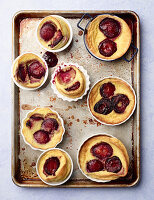 Plum Clafoutis out of the oven on baking sheet