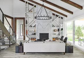 Living room sloping ceiling, marble fireplace and glass sliding doors leading to terrace