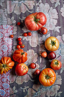 An arrangement of tomatoes on floral-patterned fabric
