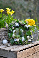 Moss wreath, decorated with ivy berries, quail eggs, hay, and feathers