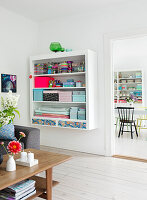 wall mounted shelf organized with craft materials in the living room