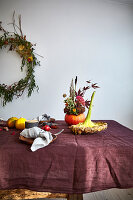 Autumn bouquet in hollowed out pumpkin and dried flower on a table