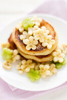 Coconut pancakes with flower shaped banana and kiwi slices