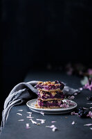 Three slices of blueberry tray cake with streusel and almonds