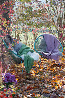 Acapulco armchair with blankets and fur in the autumn garden