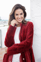 A young woman wearing a red coat