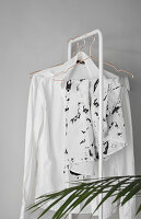 Ladies' clothing hung from white clothes rail
