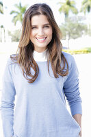 A young woman wearing a lilac jumper