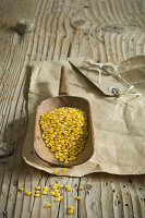 Yellow lentils on a wooden scoop