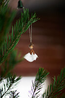 Christmas angel handmade from natural materials hanging from Christmas tree