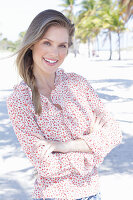 A long-haired woman wearing a floral-patterned blouse