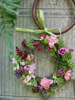 Small wreath of flowers on the zinc bucket