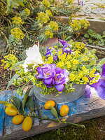 Flower arrangement and branch of kumquats